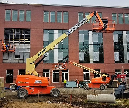 An image of a building under construction, highly saturated, moving in a circle over the text